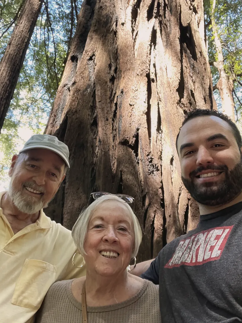 Me with Nana and Granddad at the foot of a redwood, all three squinting into the light.