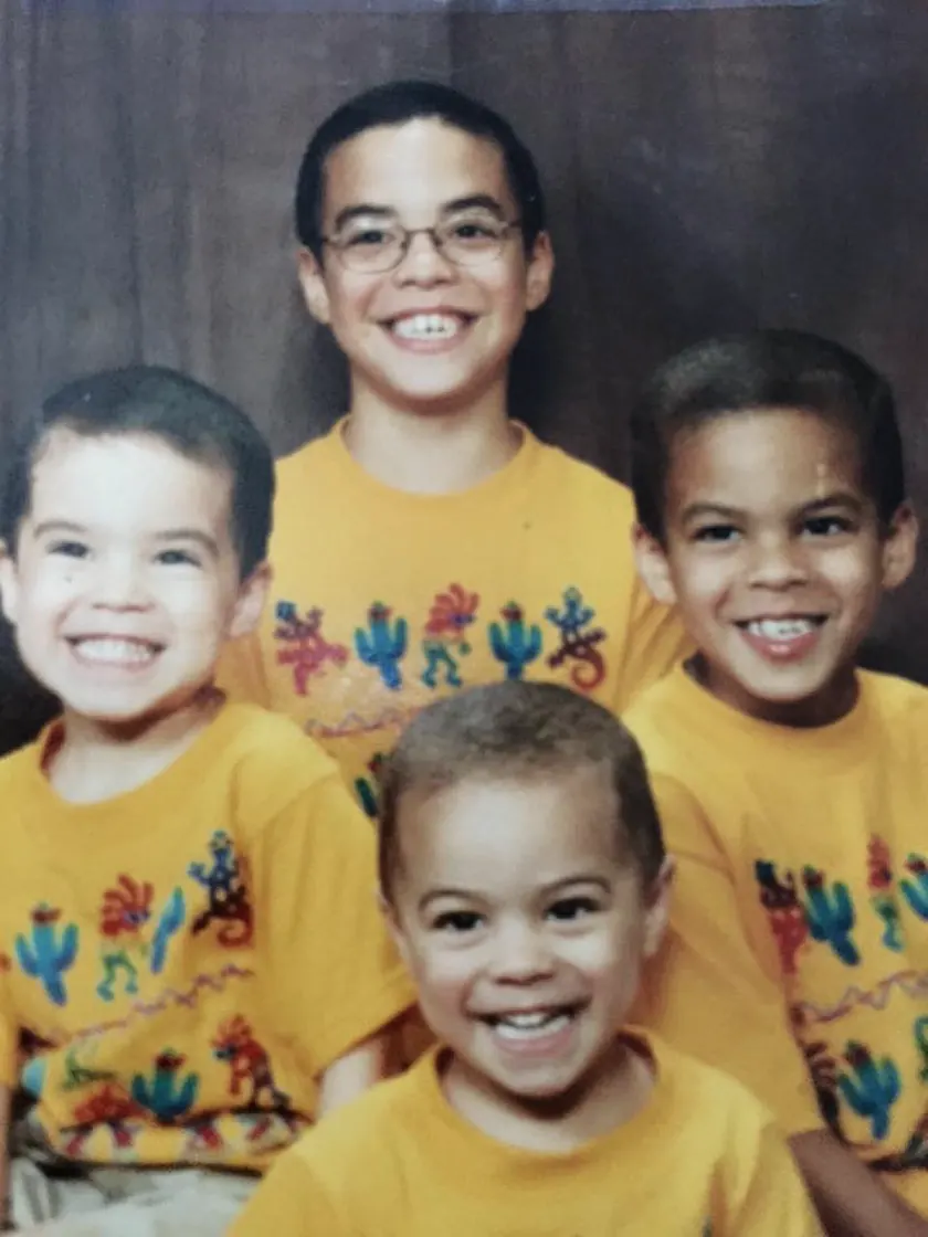 The four of us in matching yellow cactus-print shirts, posed for a studio portrait.